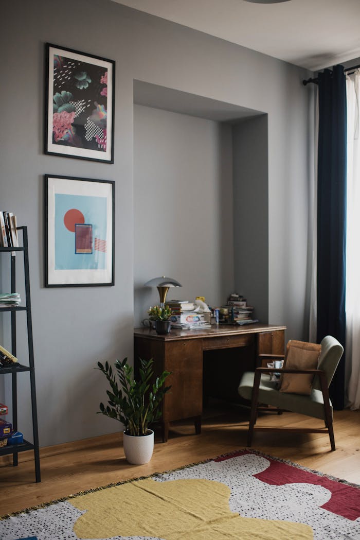 team-03 Cozy home office with vintage desk, artwork, and natural light ambiance.