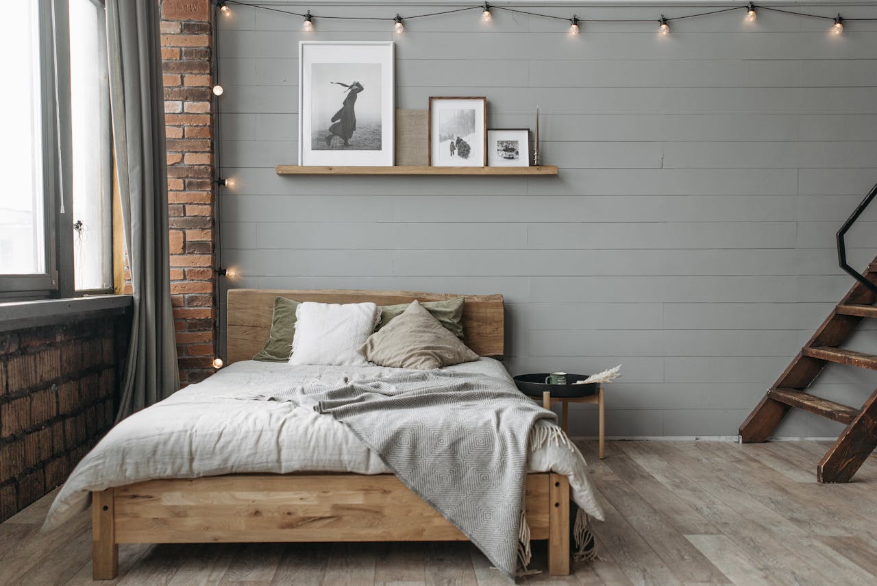 services-01 A cozy bedroom featuring wooden furniture, soft linens, and minimalist decor with natural light.